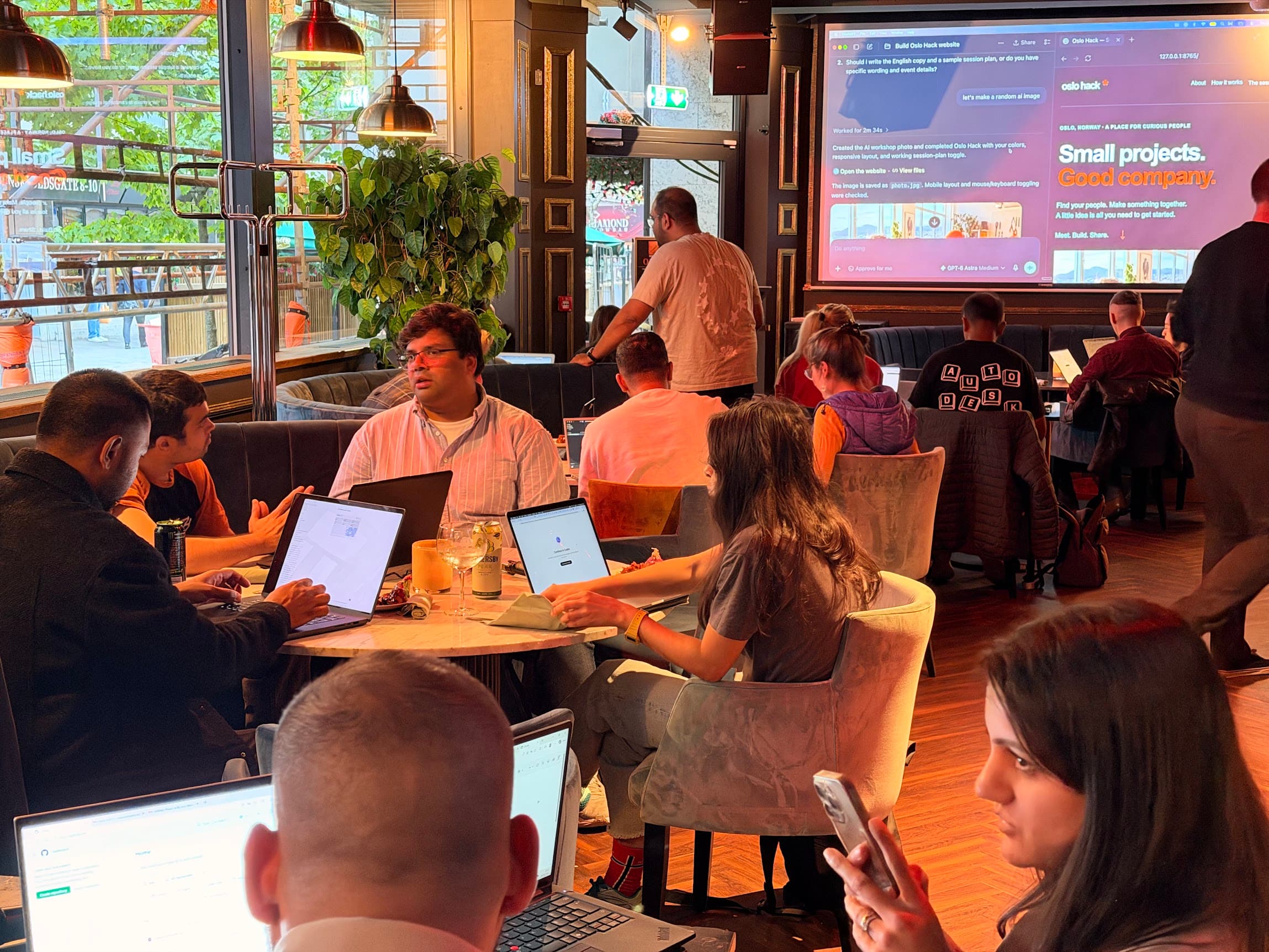 Participants building websites together while the shared project is displayed at the front of the room