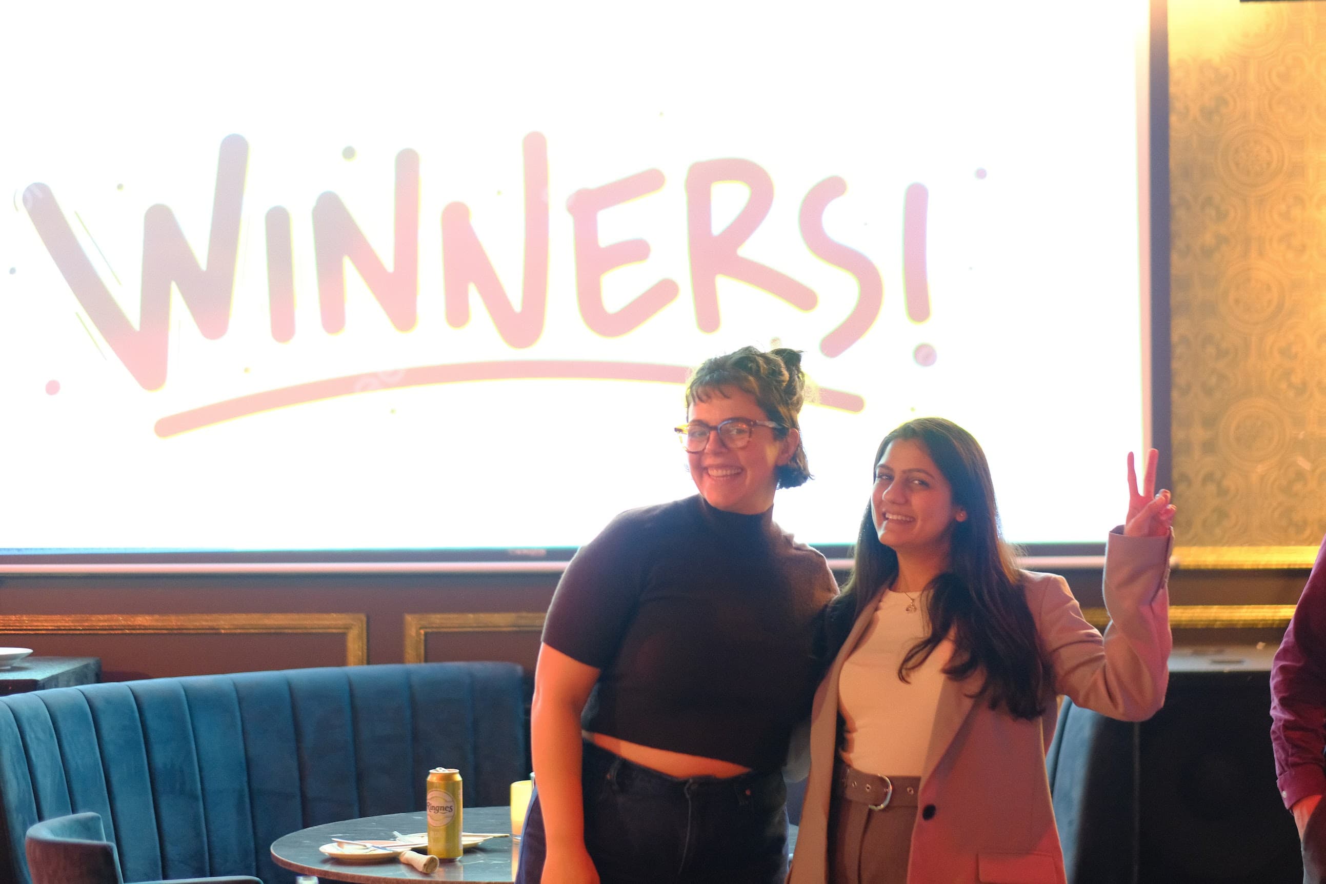 The two competition winners celebrating in front of the winners screen